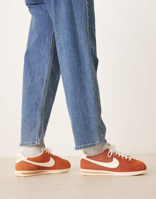 Nike Cortez suede sneakers in orange and white