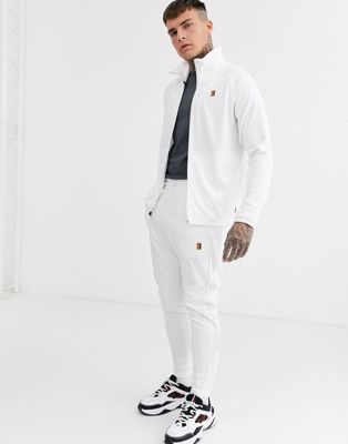 Nike Court Essential joggers in white 