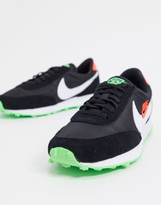 green and black nike trainers