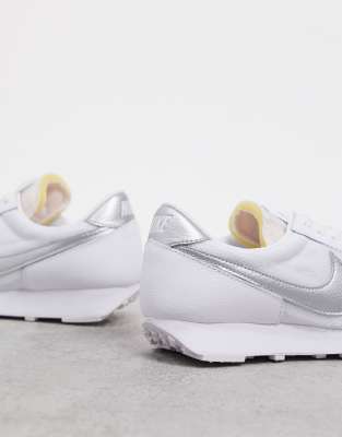 white and silver nike trainers