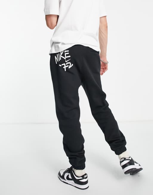 Nike Doodleglyph graphic cuffed sweatpants in black