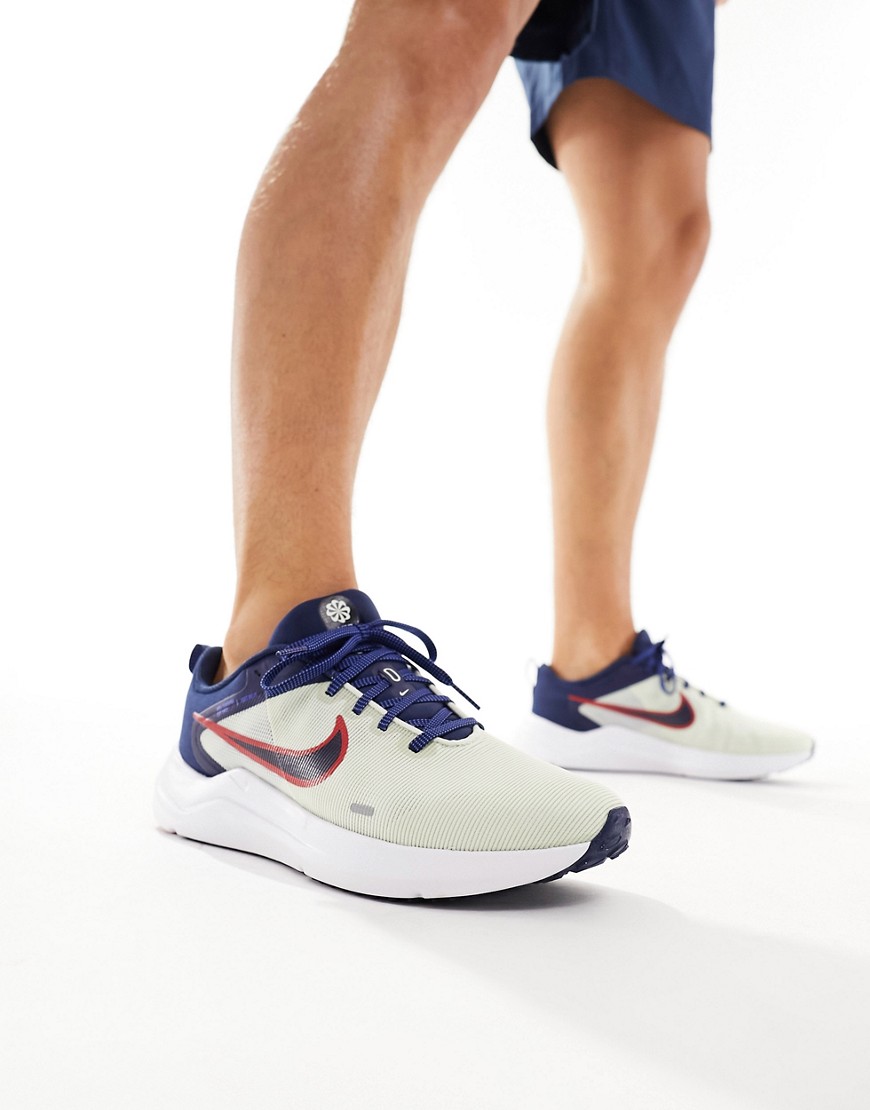 Nike Downshifter 12 trainers in white and navy