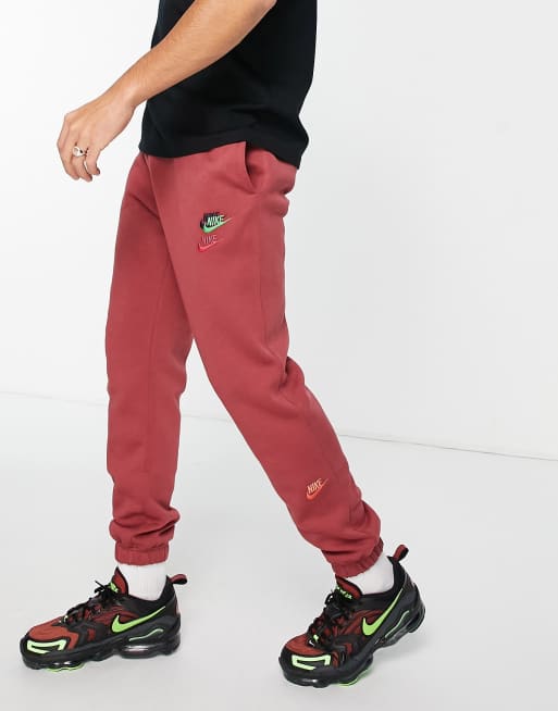 Nike Essential fleece+ multi logo casual fit cuffed joggers in cedar ASOS