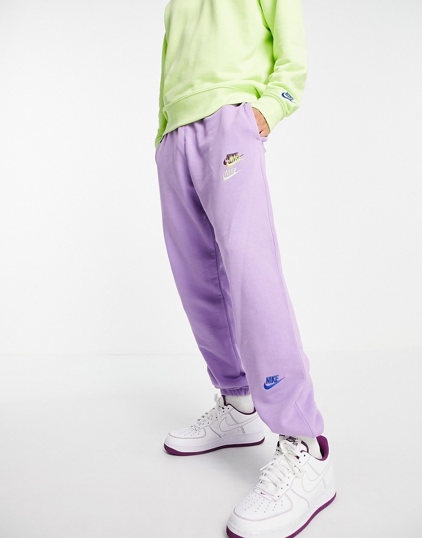 Nike Essential fleece+ multi logo casual fit cuffed joggers in lilac-Purple