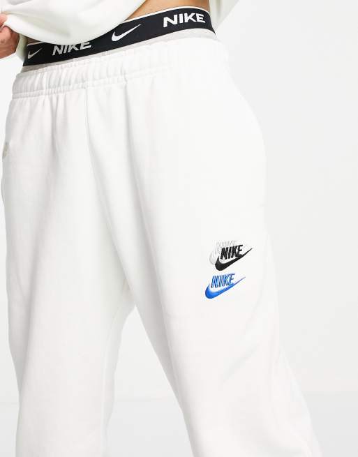 Nike Essential fleece multi logo casual fit cuffed joggers in white