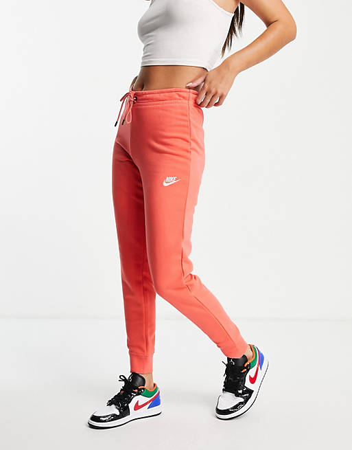 Nike essential fleece tight fit joggers in coral pink