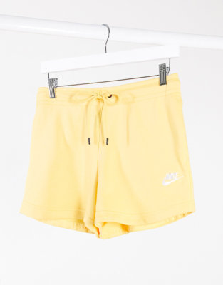 Nike essentials shorts in yellow | ASOS