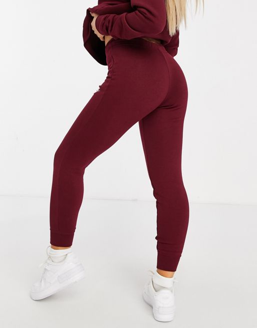 Nike Yoga jumpsuit in burgundy, ASOS