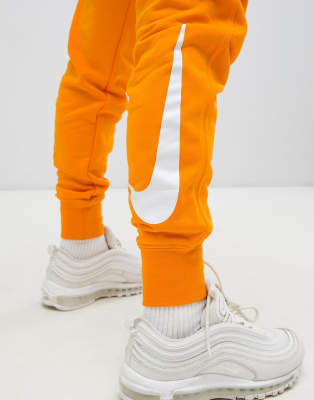 orange joggers nike