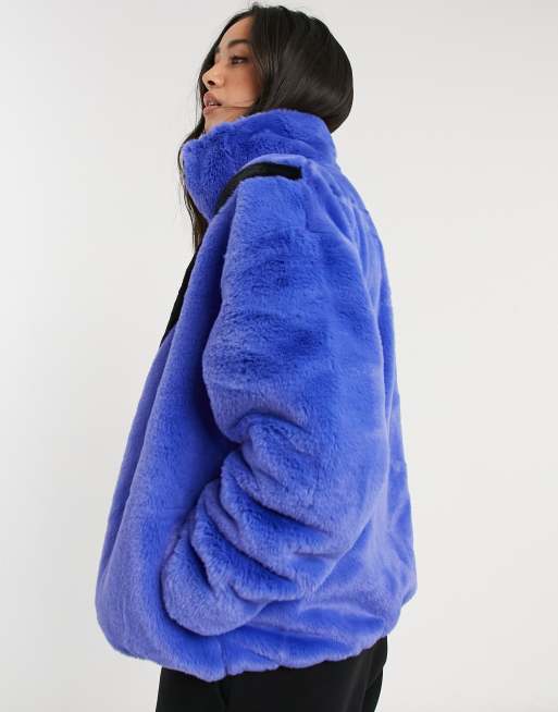 Nike faux fur oversized swoosh jacket in blue | ASOS