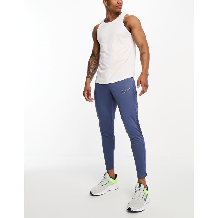 Nike track hotsell pants blue