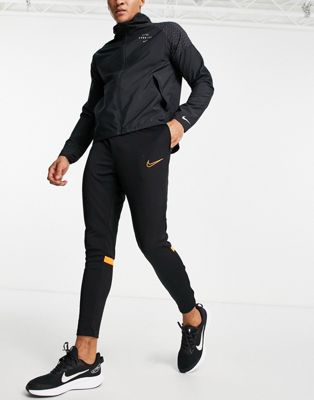 Nike Football Academy joggers in black and orange