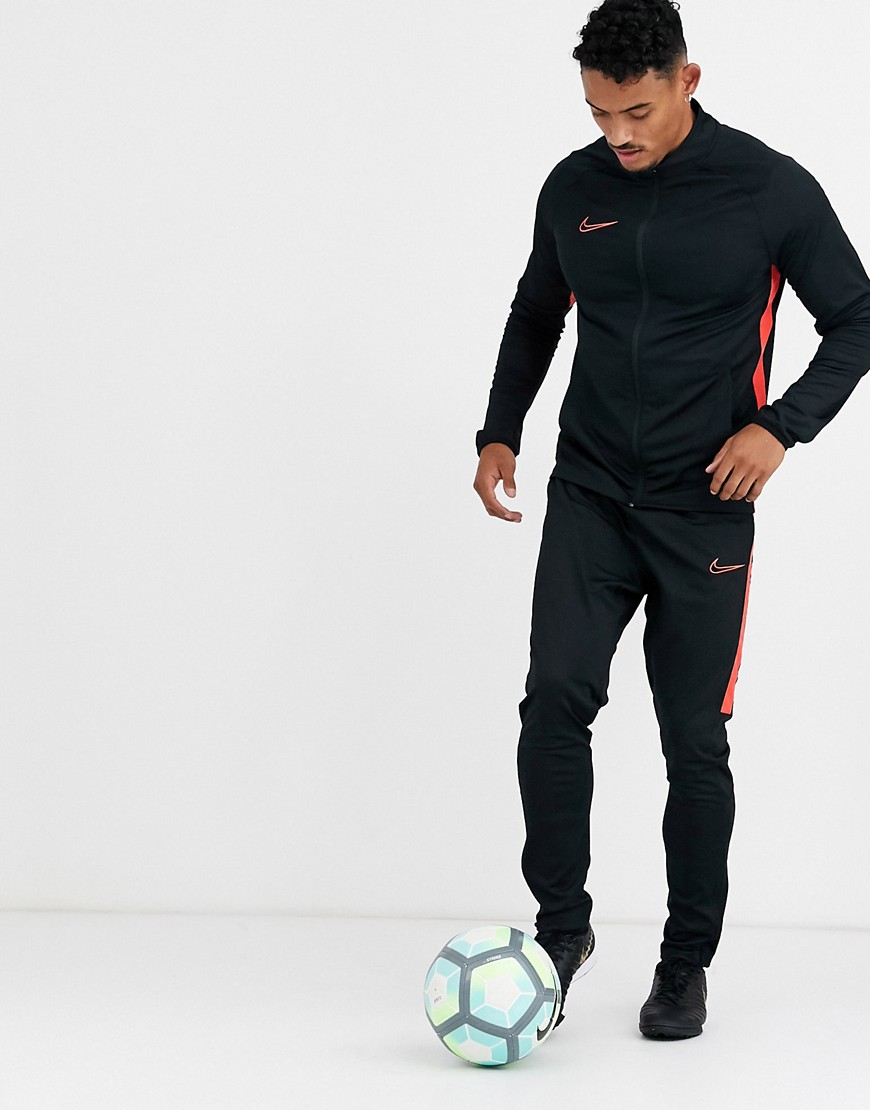 Nike Football academy tracksuit in black with red side stripe
