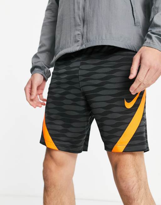 orange and black nike shorts