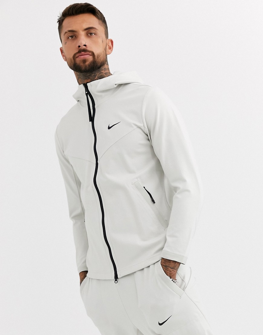 Nike - Grå sweatshirt med lynlås og techpakke