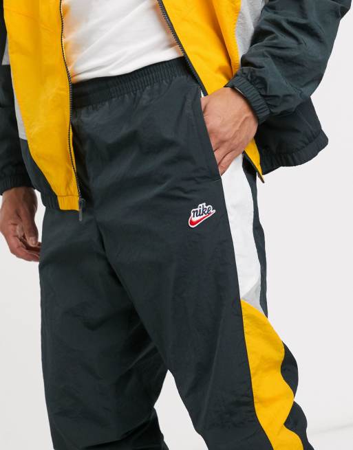 Nike Heritage cuffed woven joggers in yellow green ASOS