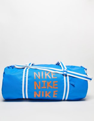 Nike Heritage duffel bag in blue with orange 'Nike' logo