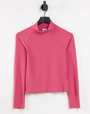 Nike Icon Clash mock neck long sleeve top with all over swoosh in archaeo pink