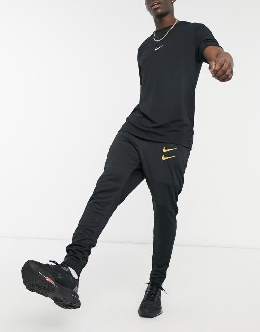 Nike Jogger a logo virgule Noir et dore ASOS