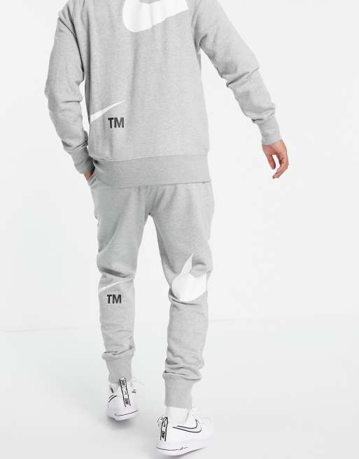 nike jogger en polaire à logo virgule gris