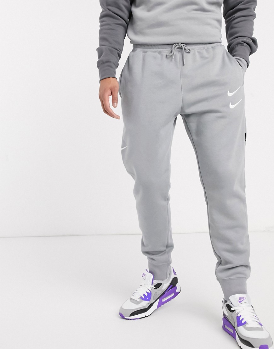 Nike - Joggers con fondo elasticizzato e logo Nike grigi-Grigio