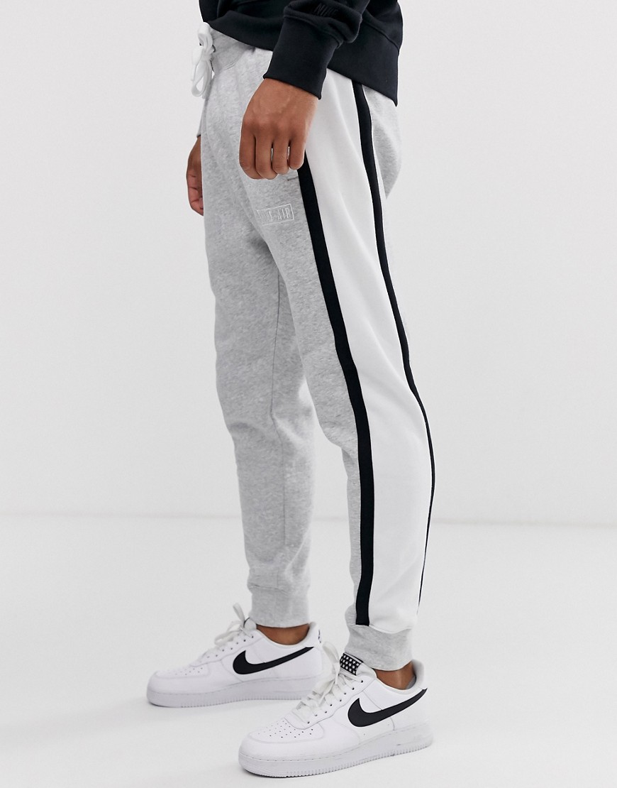 Nike - Joggers con fondo elasticizzato grigi con righe a contrasto-Grigio