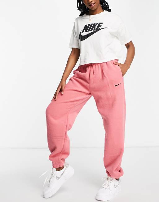 Nike - Joggers felpati rosa archaeo a vita alta con logo Nike piccolo