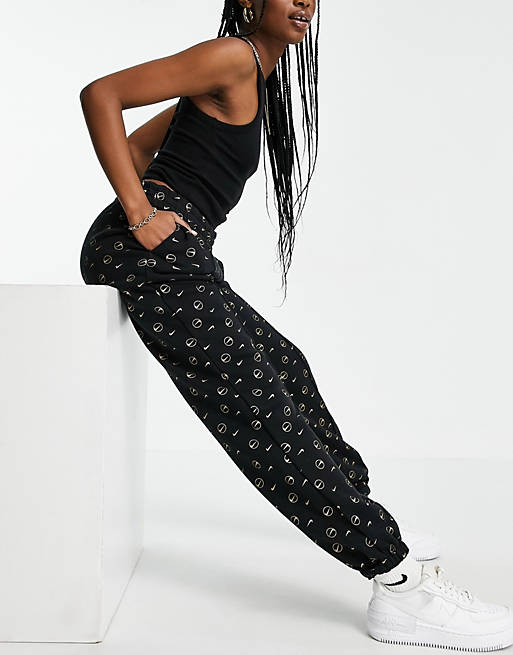 Nike joggers in black all over logo print | ASOS