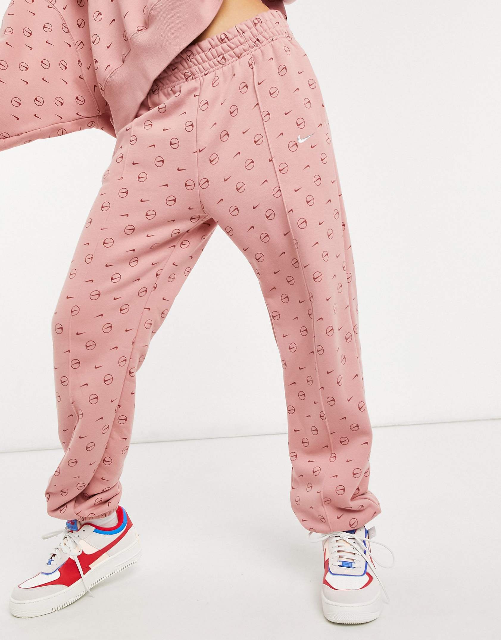 Nike joggers in rustic pink all over logo print ASOS Price Checker