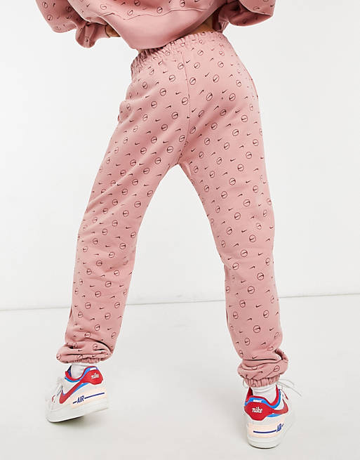  Nike joggers in rustic pink all over logo print 