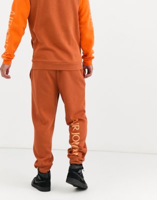 orange nike jogging suit