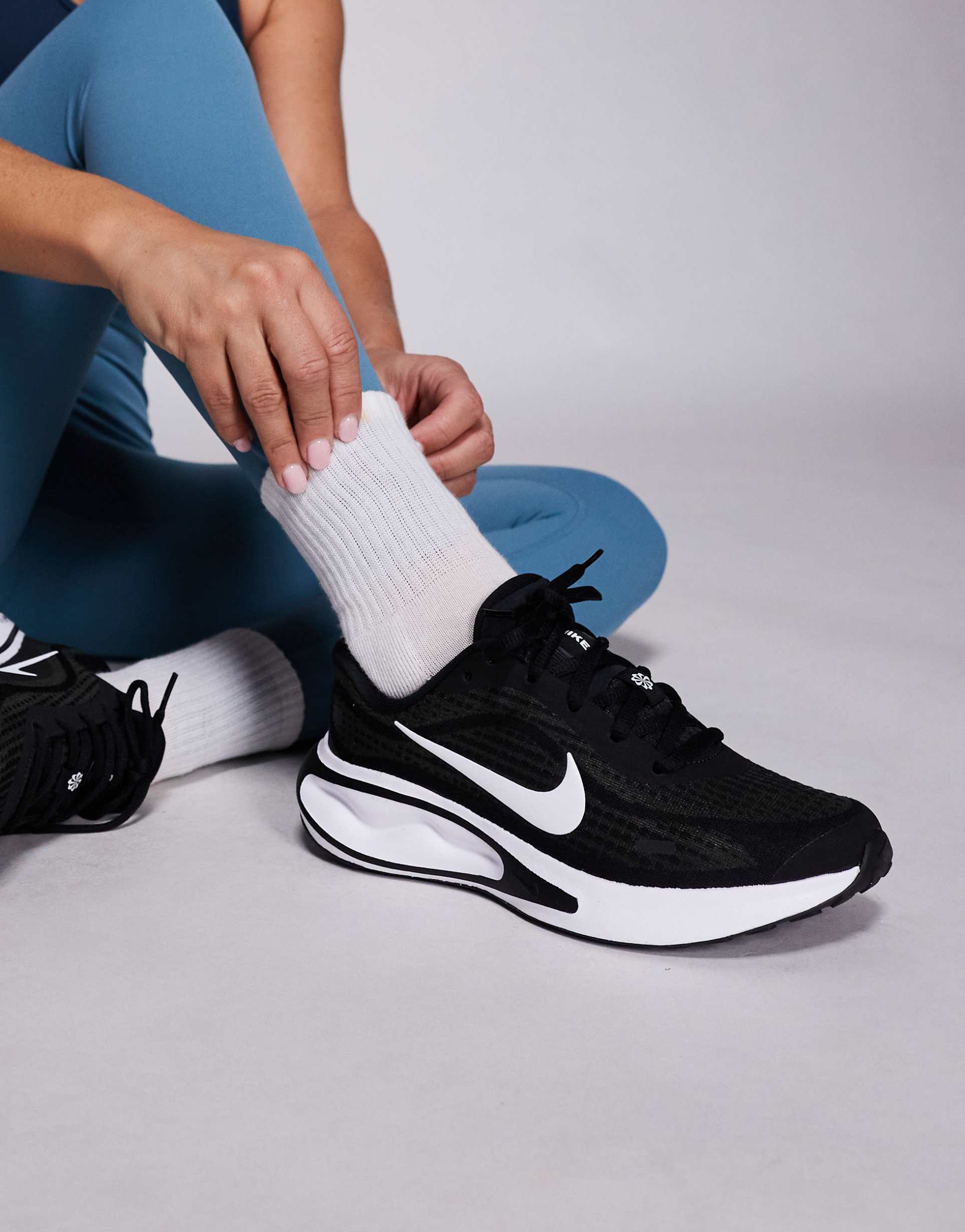 nike journey run sneakers in black and white