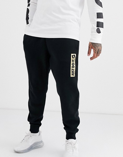 Nike Just Do It metallic logo cuffed joggers in black | ASOS