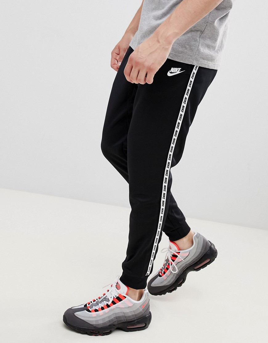 Nike logo taping cuffed joggers in black