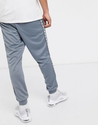 Nike logo taping cuffed joggers in grey 