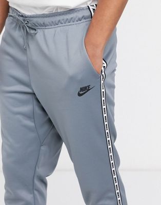 Nike logo taping cuffed joggers in grey 