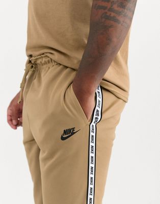 Nike logo taping cuffed joggers in sand 