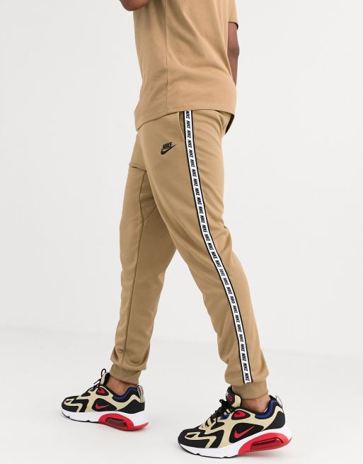 Nike logo taping cuffed joggers in sand ASOS