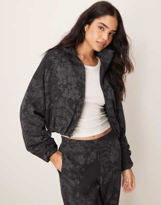 Nike - MDC - Jacquard-Jacke in Schwarz und Grau mit Blumenmuster