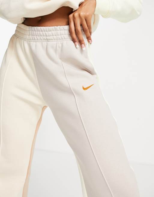 Nike Mini Metallic Swoosh Oversized Joggers In Cream-white from