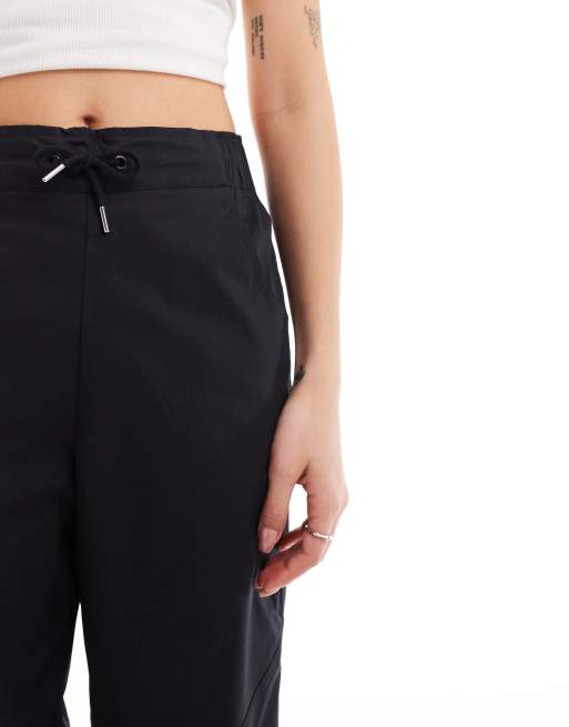 Nike Swoosh high-waisted woven pants in black