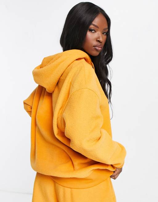 Nike mini swoosh discount oversized yellow hoodie