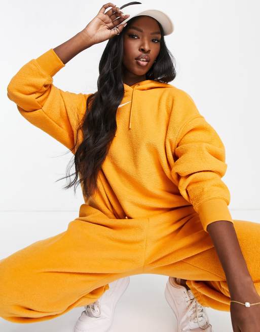 Nike mini swoosh oversized best sale yellow hoodie