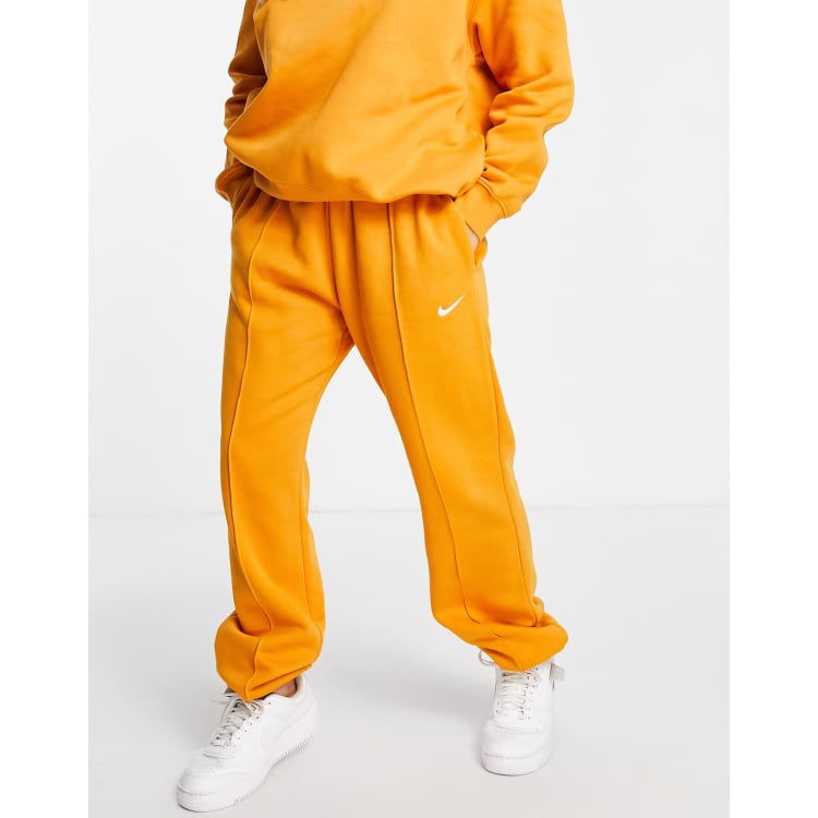 Nike track pants orange clearance