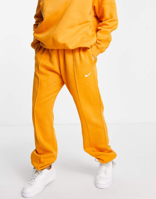 Nike mini swoosh oversized joggers in orange