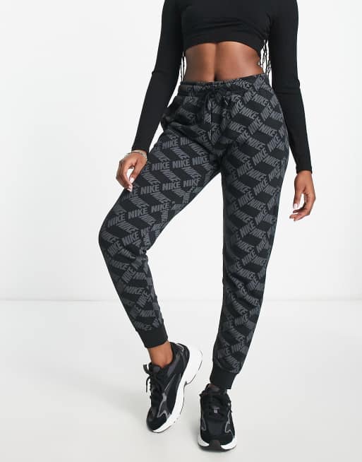 Nike Monogram all over logo print fleece cuffed sweatpants in black