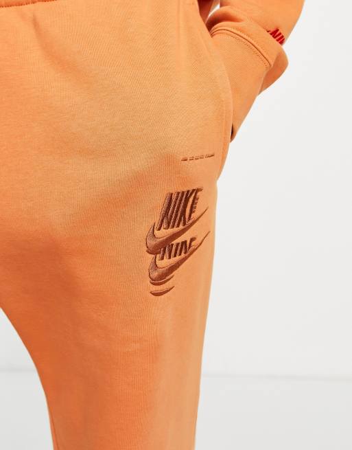 Nike Multi-Futura cuffed fleece sweatpants in dusty orange ASOS