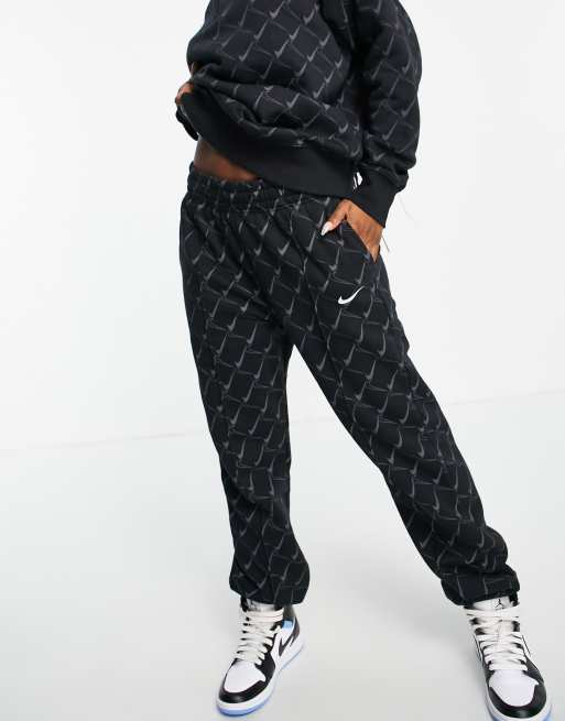 Nike oversized joggers in black with all over swoosh print