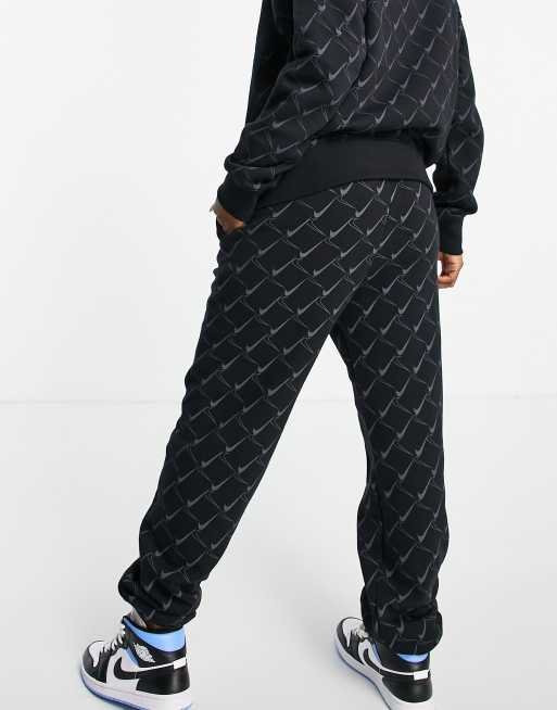 Nike Monogram all over logo print fleece cuffed sweatpants in black