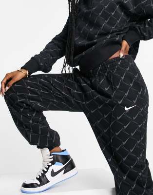 nike pants with swoosh all over